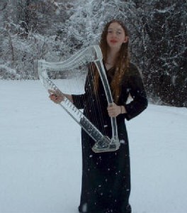 Girl in snow holding harp
